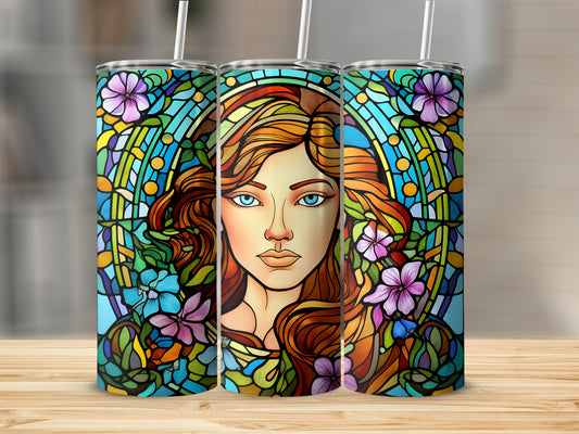 Stained glass tumbler featuring a woman with auburn hair and blue eyes.