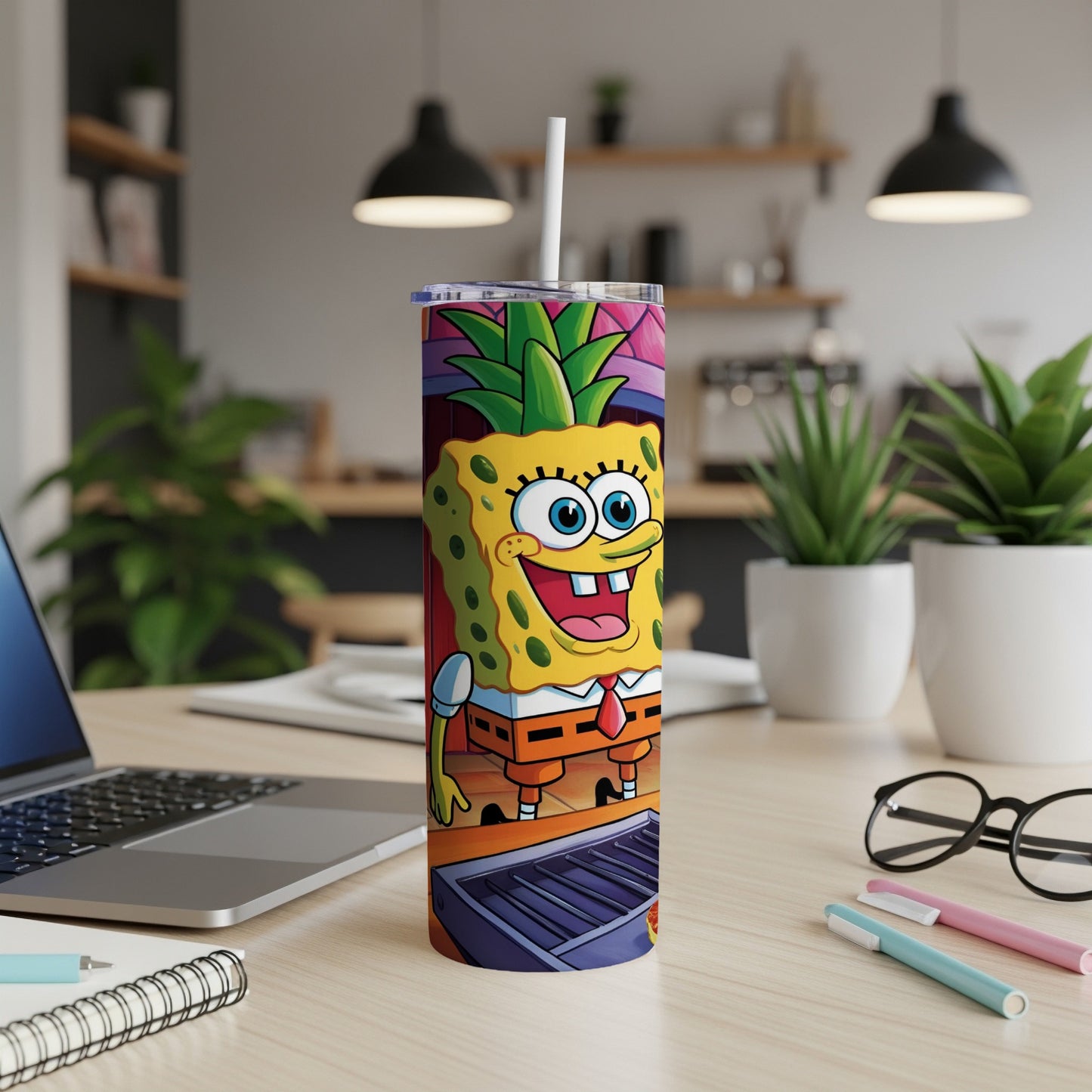 SpongeBob SquarePants tumbler with straw on a desk.