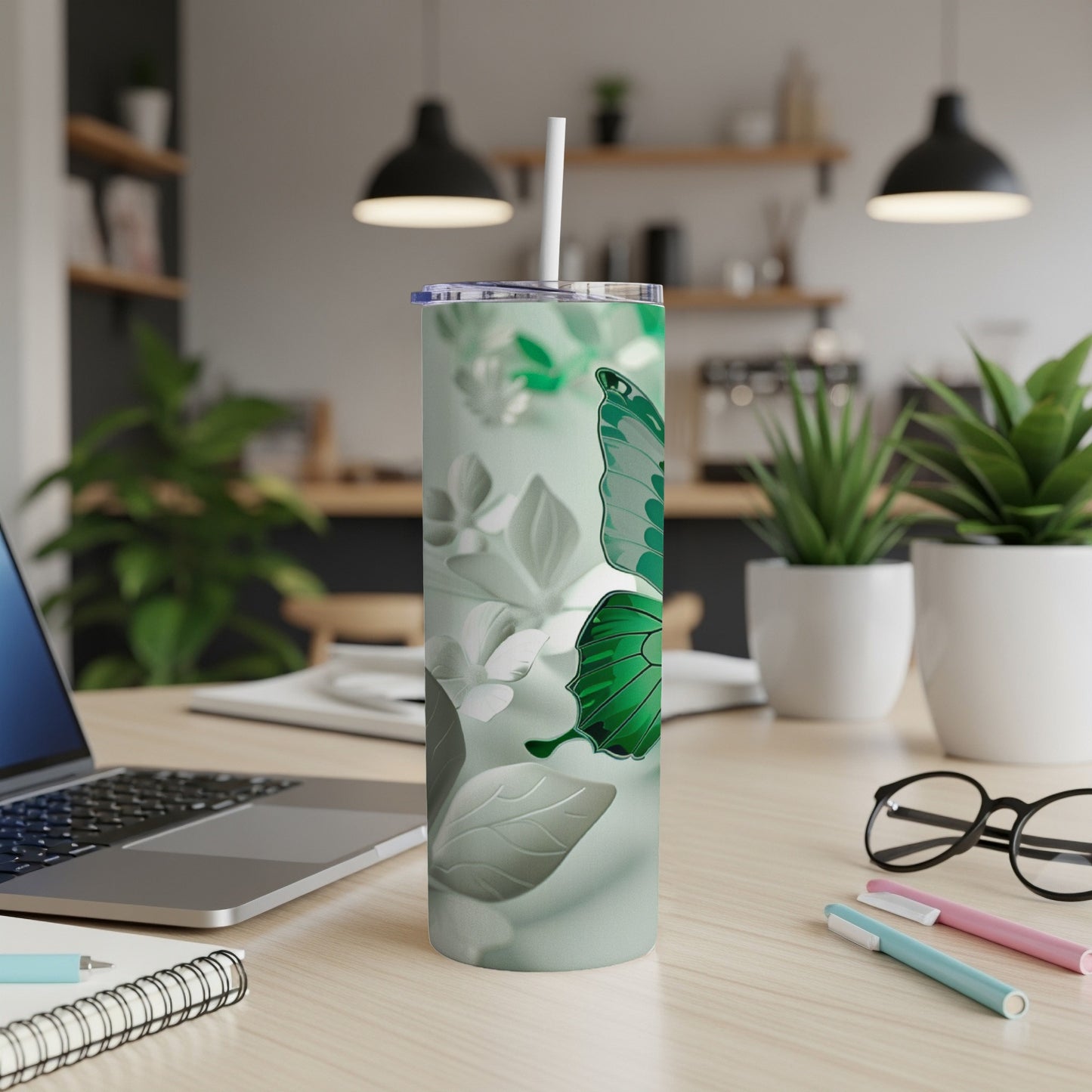 Green butterfly on a mint green skinny tumbler with straw.