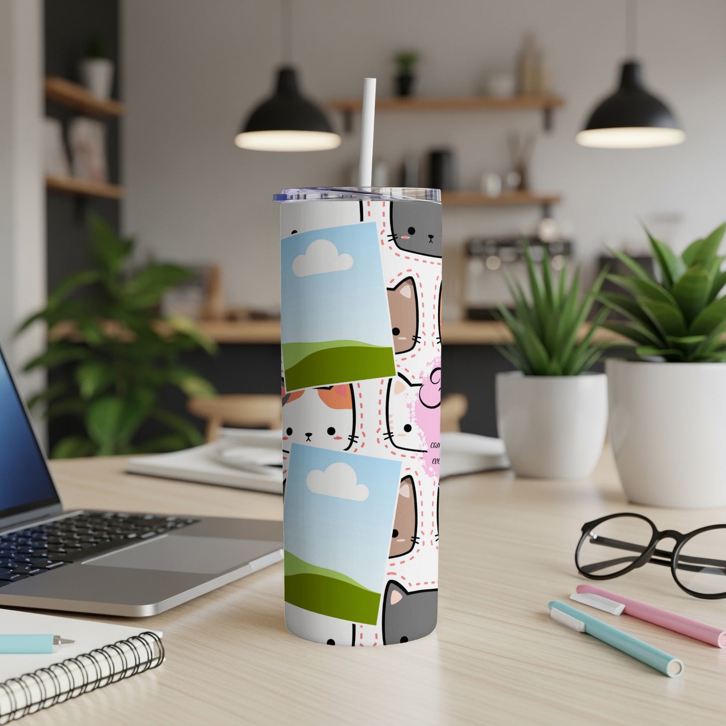 White tumbler with a repeating pattern of cartoon cats and small picture frames.