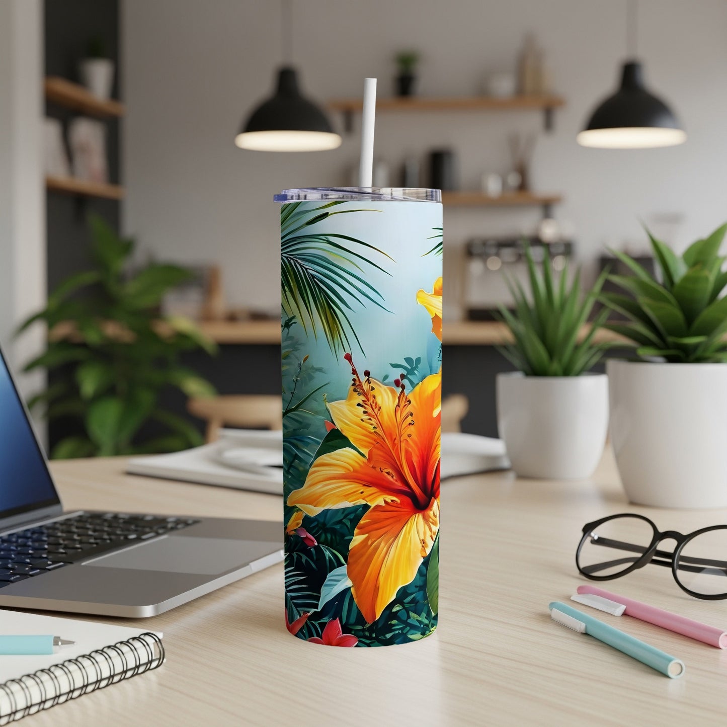 Orange hibiscus flower with green leaves on a tropical themed tumbler.