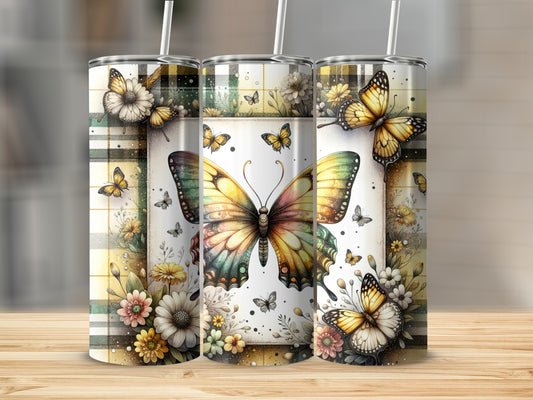 Three tumblers with butterflies and floral patterns on a wooden surface.