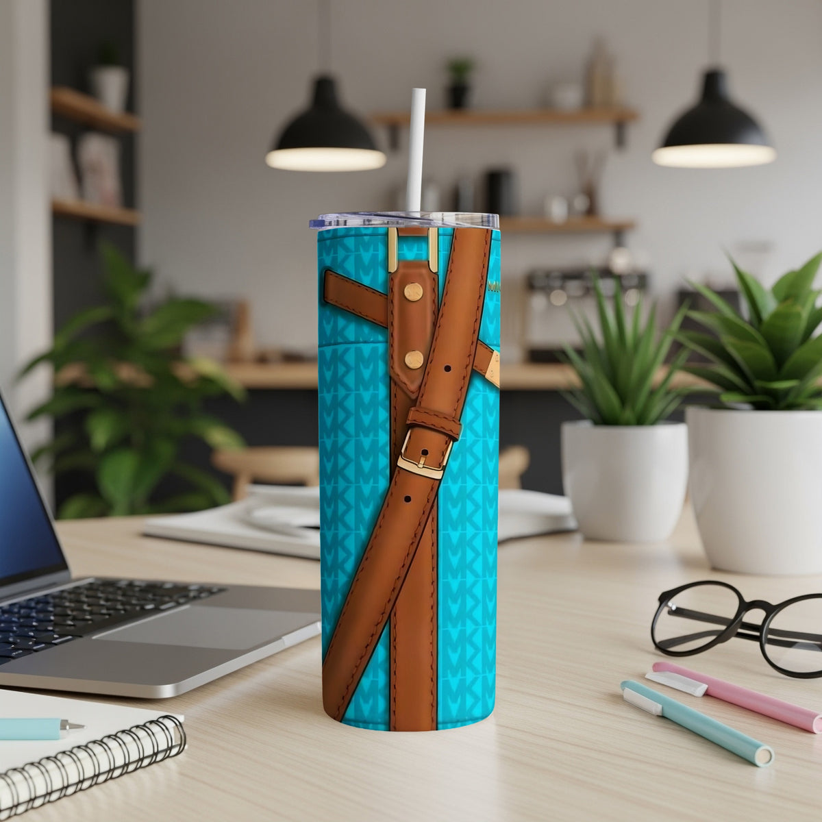 Turquoise tumbler with brown buckle straps and a repeating MK logo pattern.