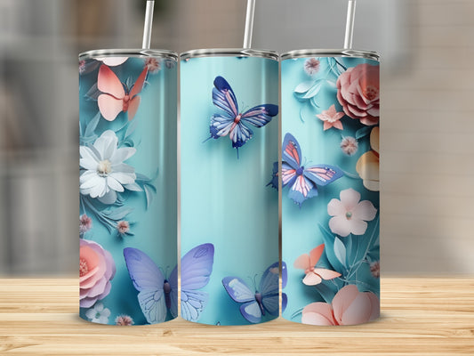 Three turquoise tumblers with pastel butterflies and flowers, on a wooden surface.