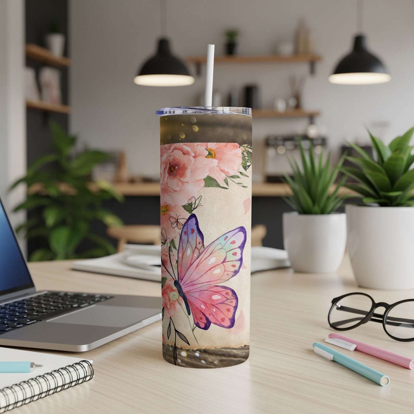 Tumbler with pink roses and a watercolor butterfly design and straw.