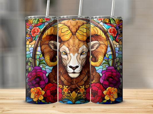 Stained glass tumbler with a ram's head and floral accents.