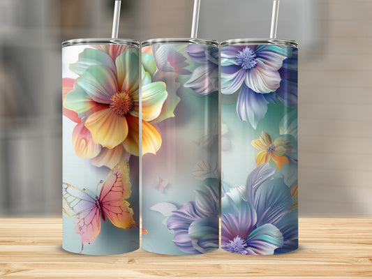 Three tumblers with colorful floral and butterfly designs on a wooden surface.