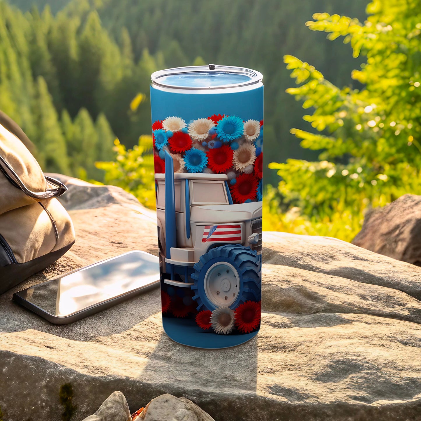 Tumbler with a white tractor design and red, white, and blue flowers.