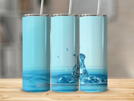 Three blue tumblers with water splash on wooden table.
