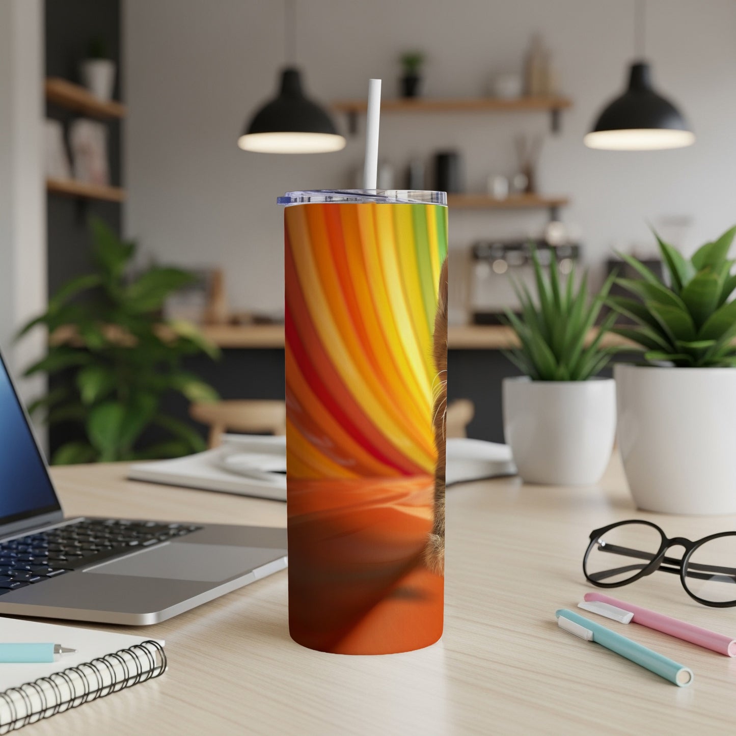 Tumbler with a rainbow-striped design and a cat's face peering from the side.