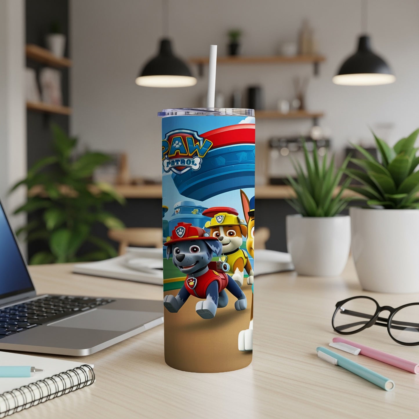 Paw Patrol characters Chase, Marshall, and Rubble on a blue and brown tumbler.