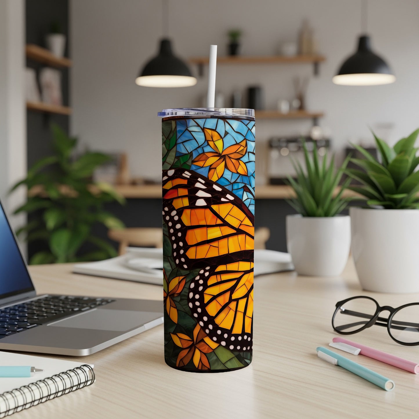 Monarch butterfly and floral stained glass design on a white tumbler.