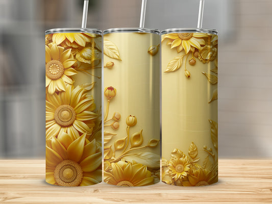 Three gold tumblers with raised floral and leaf designs on a wooden surface.
