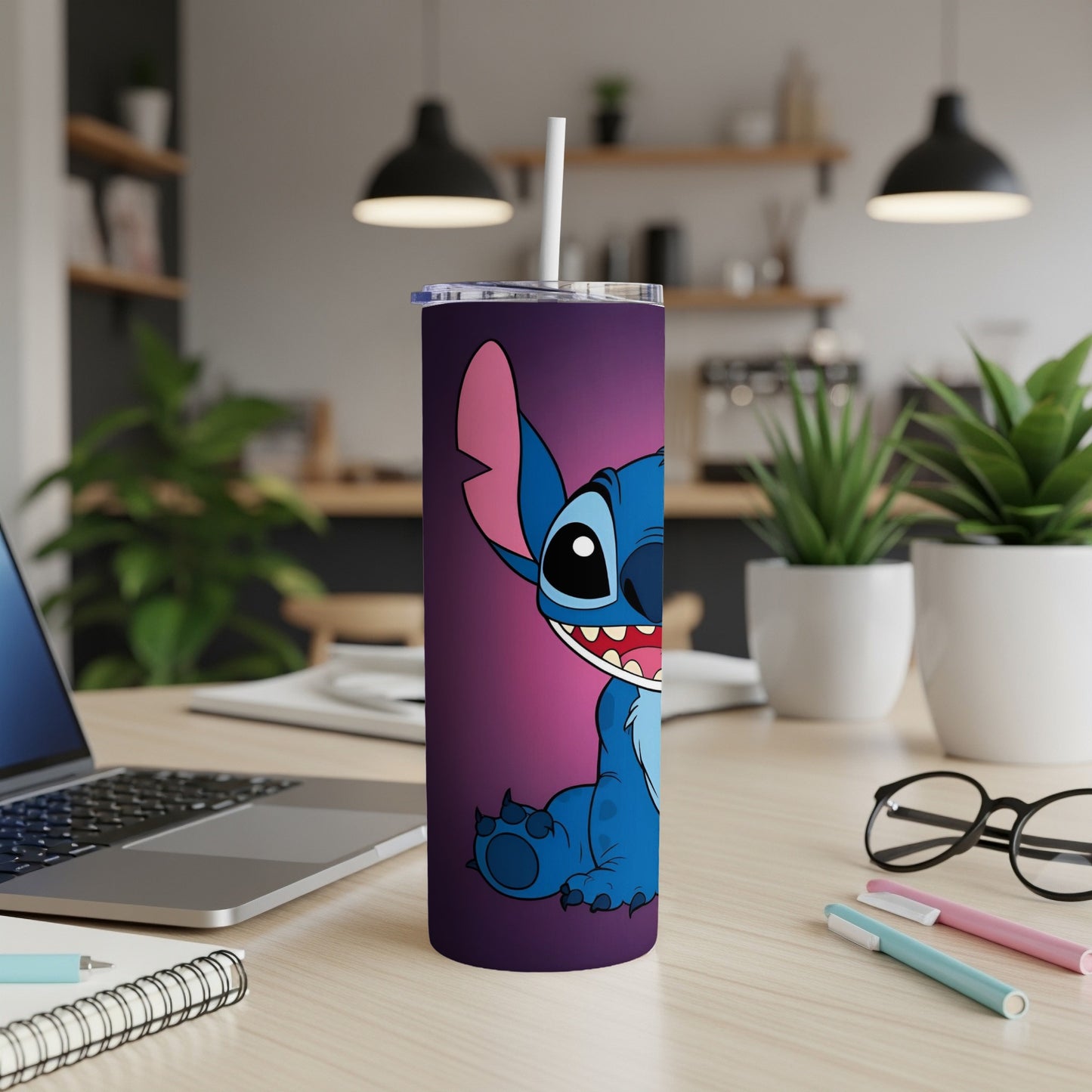 Blue Stitch character on a purple tumbler with straw on a desk.