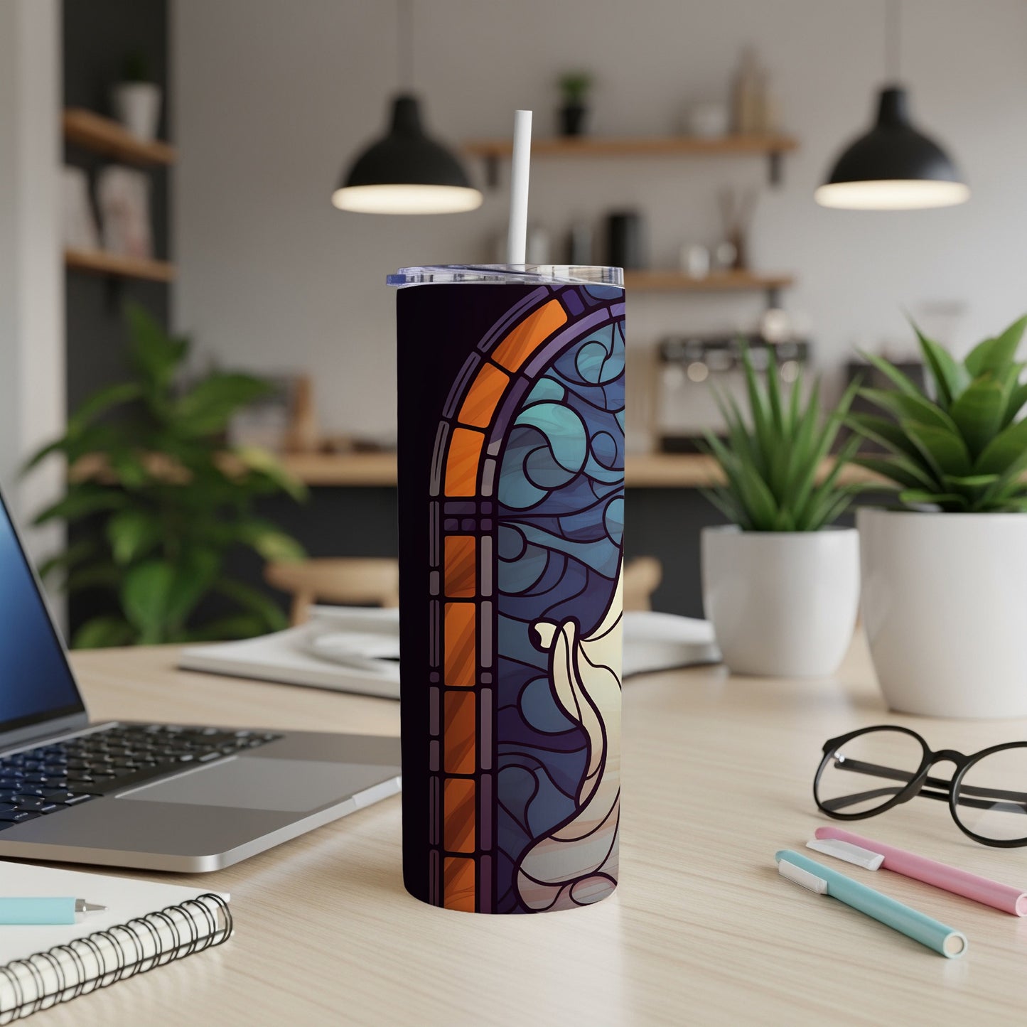 Stained glass design on a dark tumbler with a white straw.