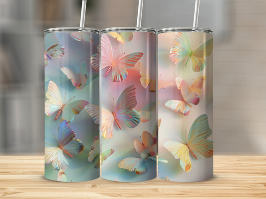 Three tumblers with pastel butterfly designs on a wooden surface.