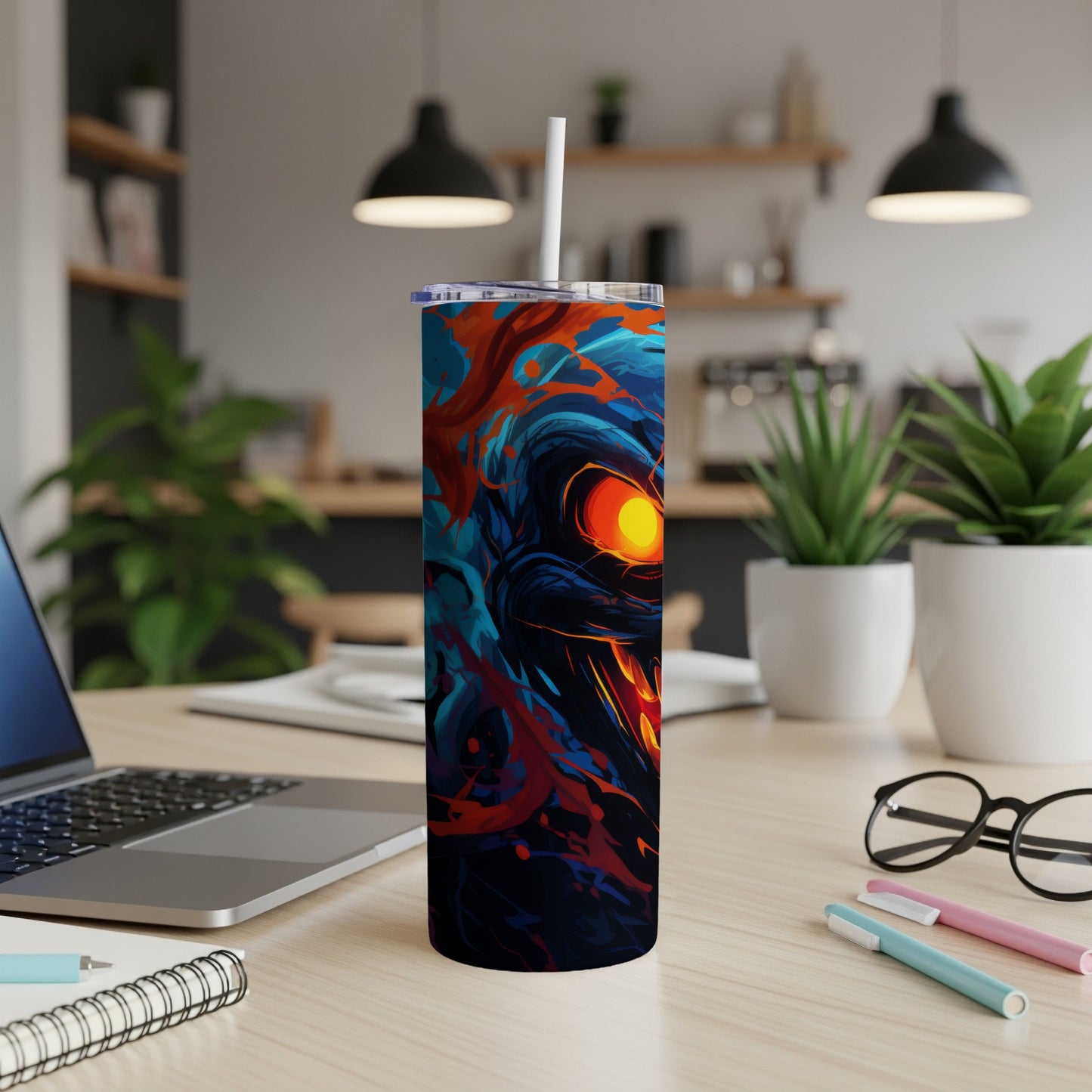 Tumbler with abstract fiery creature design and a white straw.