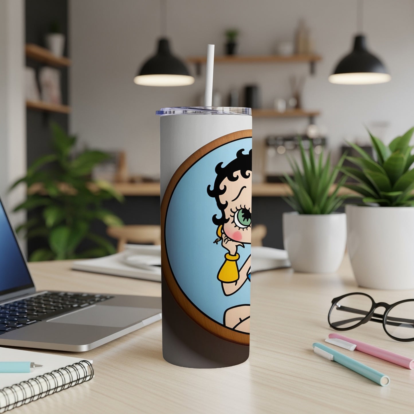 Betty Boop illustration on a white tumbler with a straw.