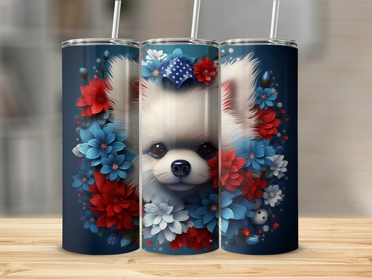 Pomeranian dog in patriotic floral wreath on navy blue tumbler.