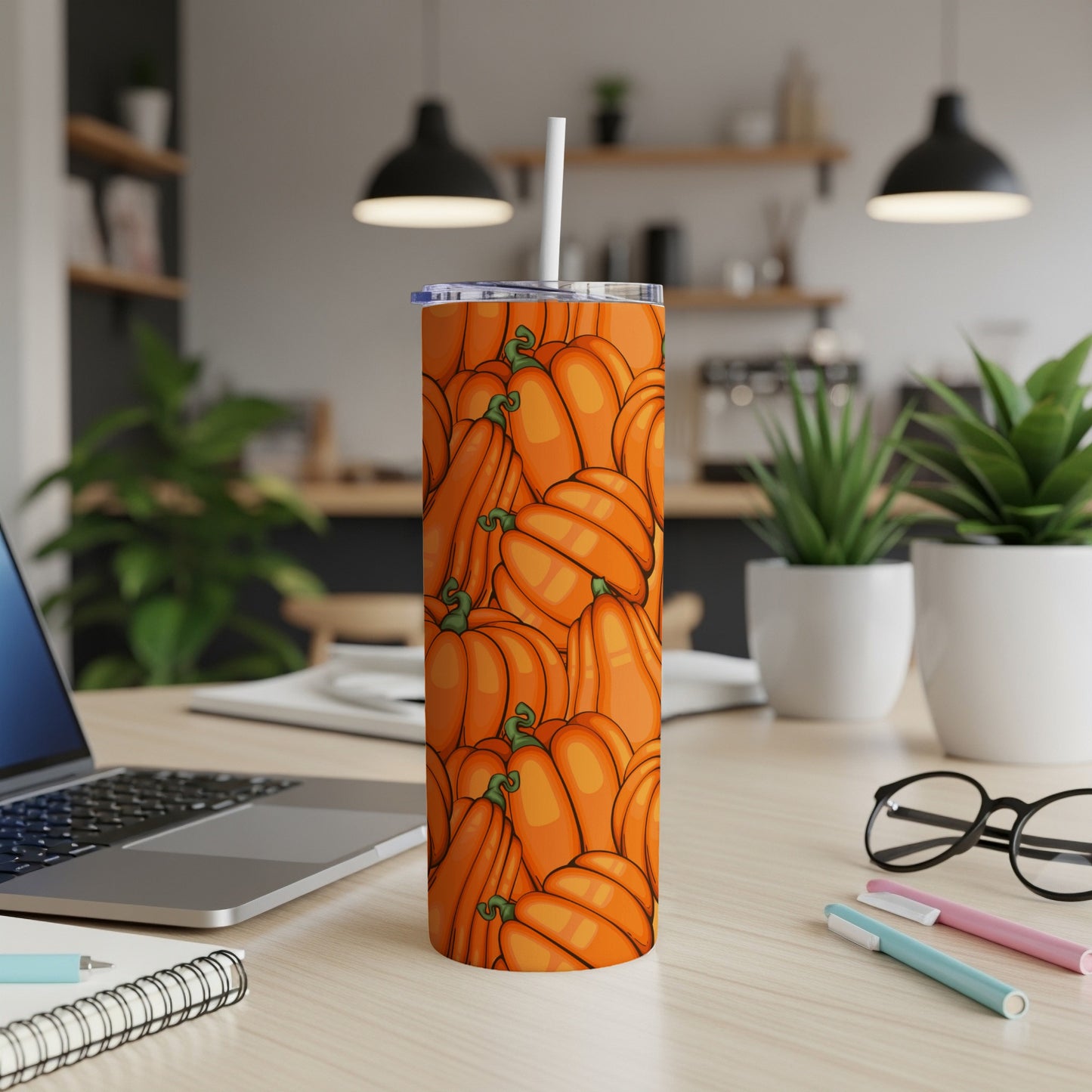 Orange pumpkins pattern on a white tumbler with a straw.