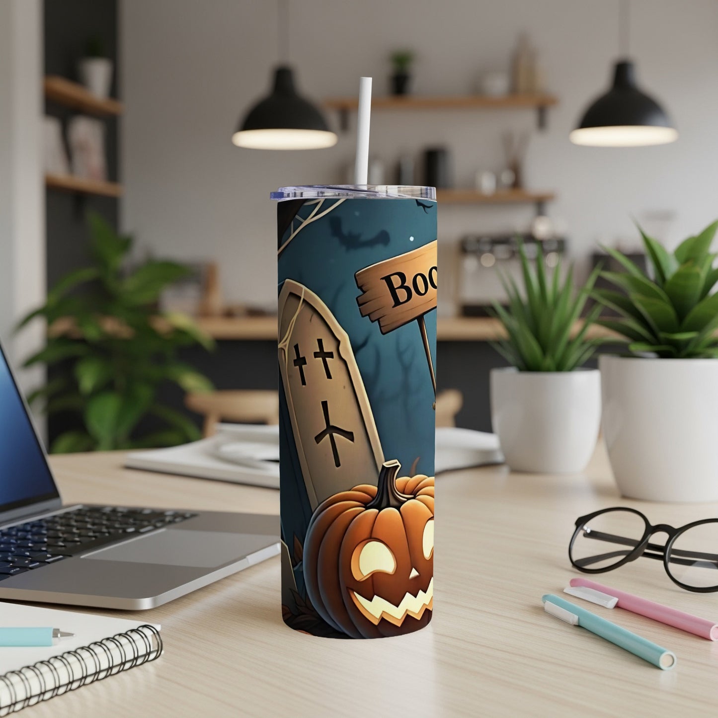 Tumbler with Halloween design featuring a tombstone, jack-o'-lantern, and "Boo" sign.