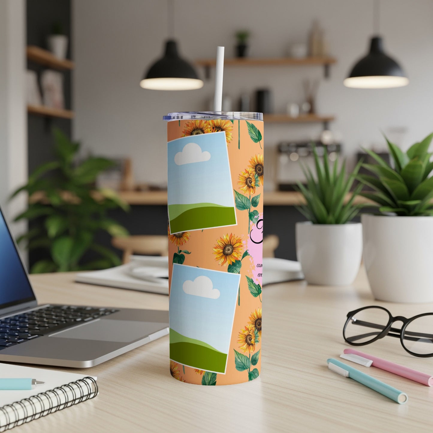 Tumbler with sunflowers and empty photo frames on an orange background.