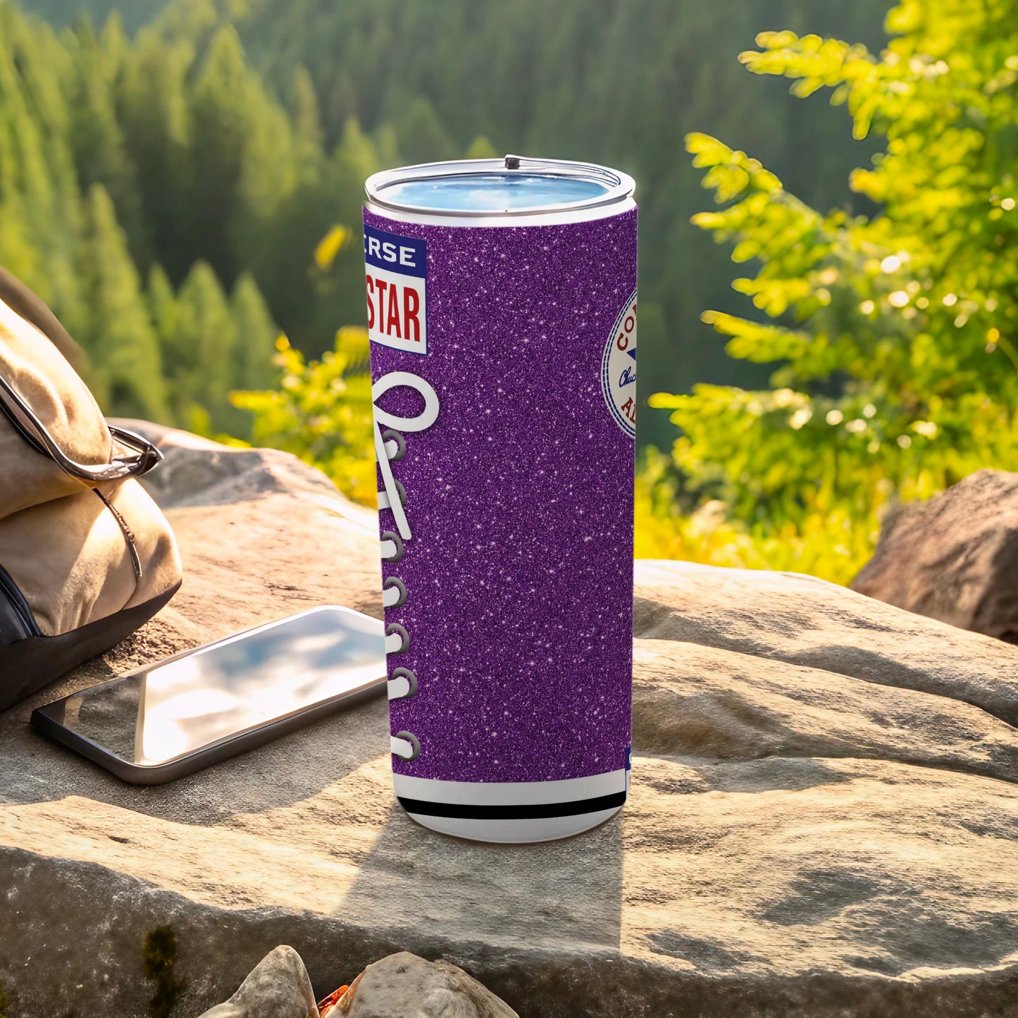 Purple glitter Converse Chuck Taylor All Star tumbler on rocky surface.