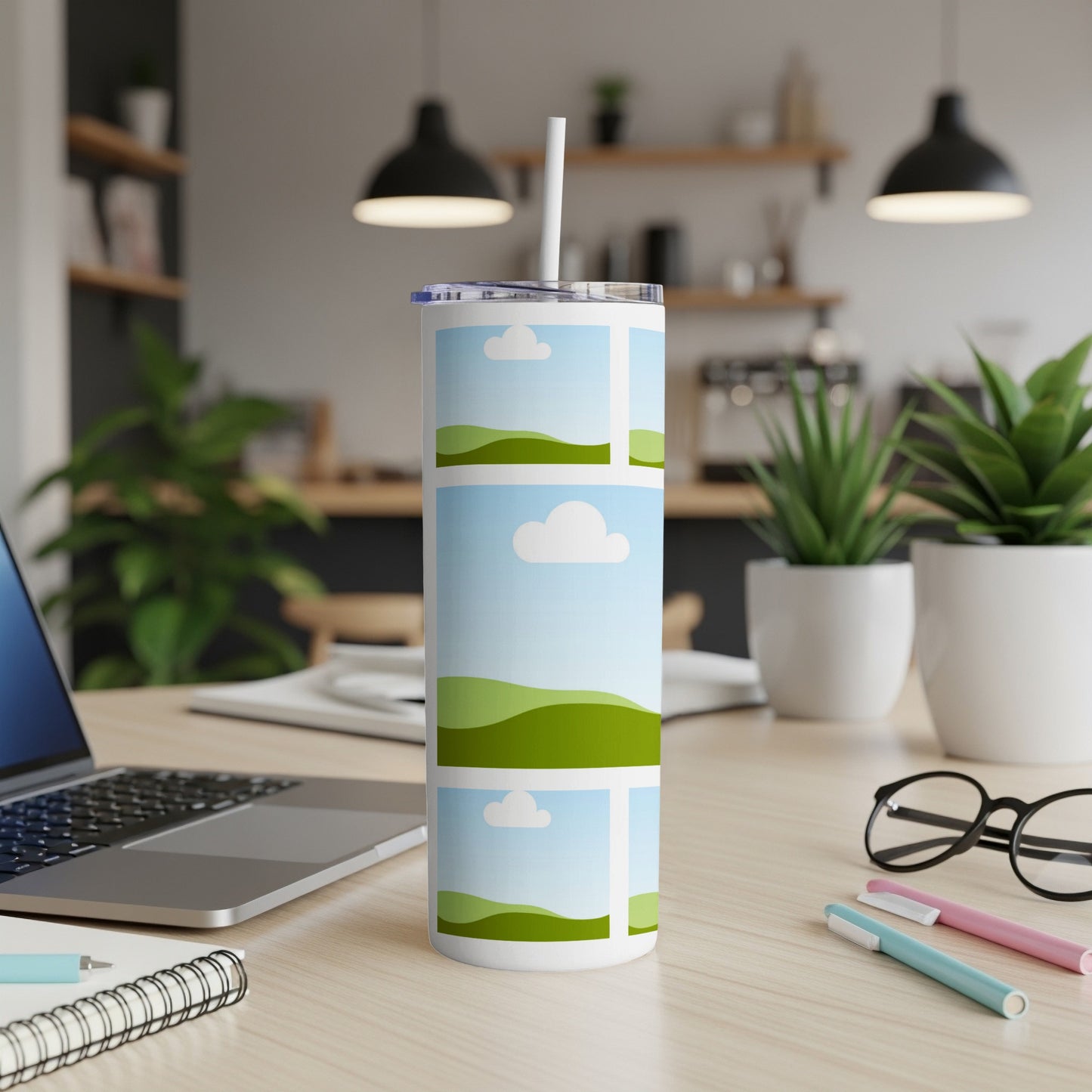 White tumbler with a pastoral landscape design and a straw.