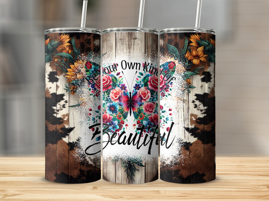 Tumbler with cow print, floral designs, and "Be Your Own Kind of Beautiful" text.