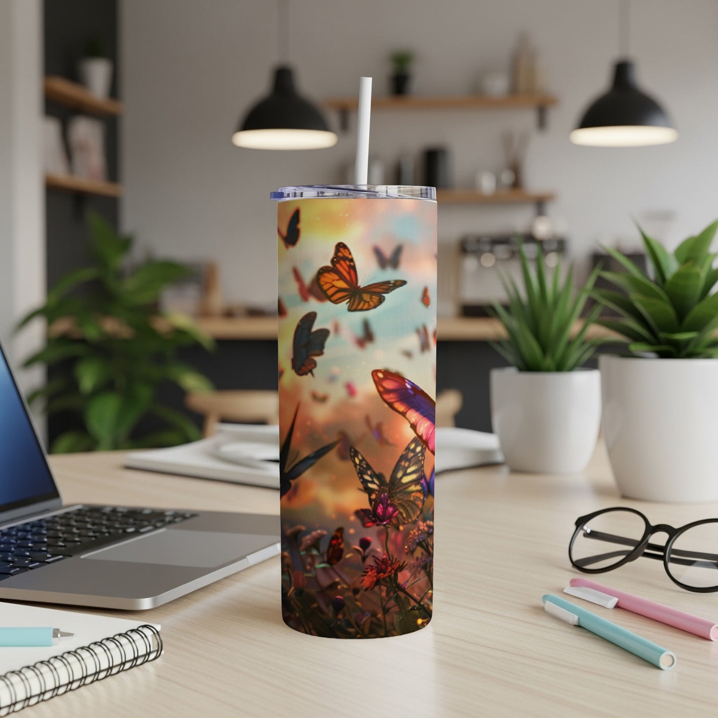 Butterfly pattern on a white skinny tumbler with a straw.