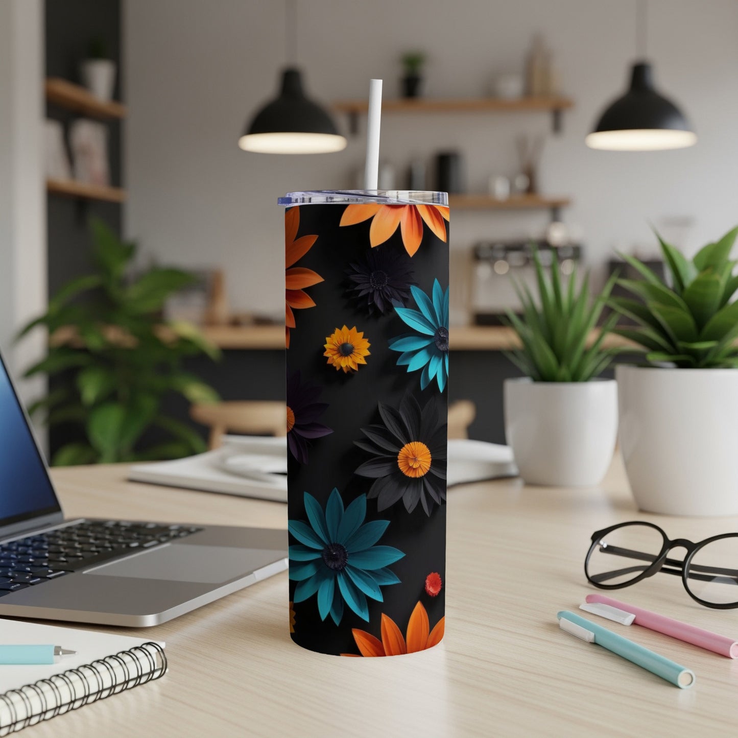Black tumbler with colorful floral pattern and white straw.