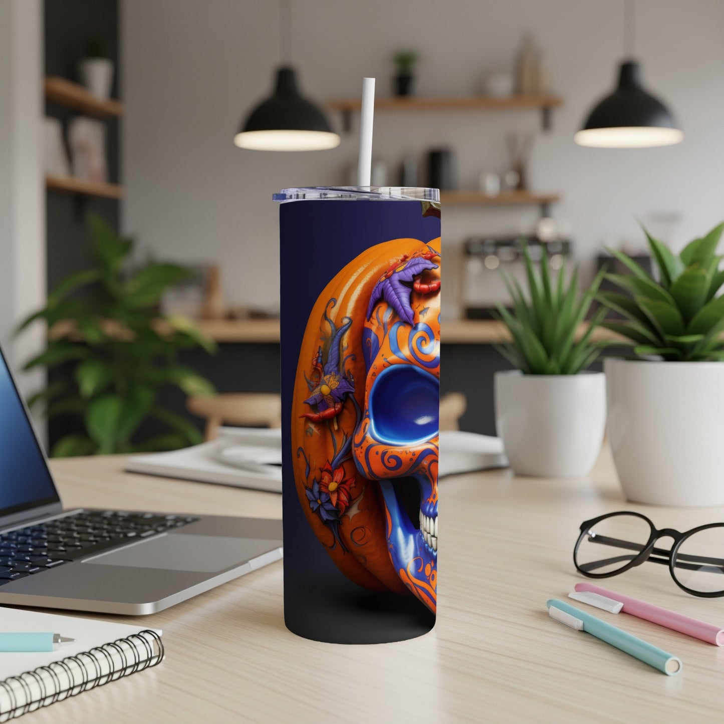 Tall tumbler with colorful pumpkin skull design and straw.