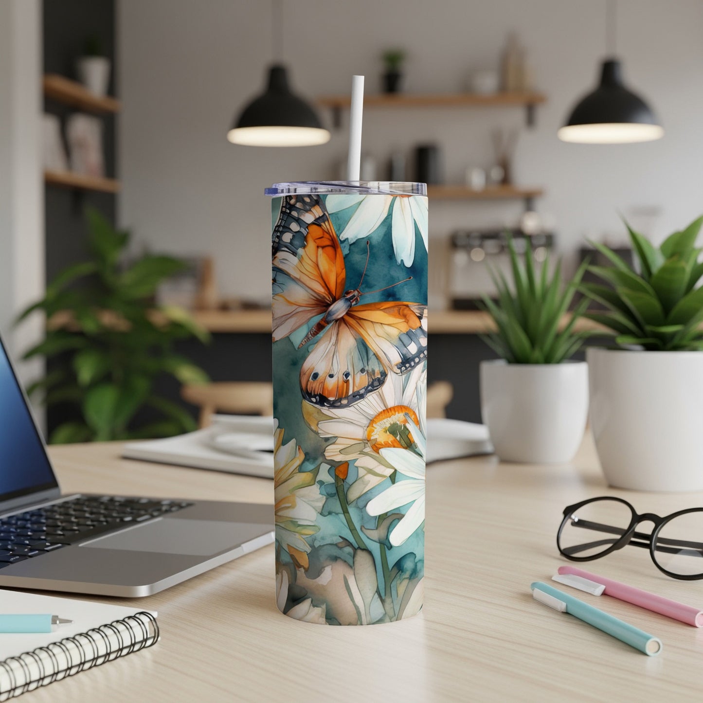 Tall tumbler with monarch butterfly and floral watercolor design.