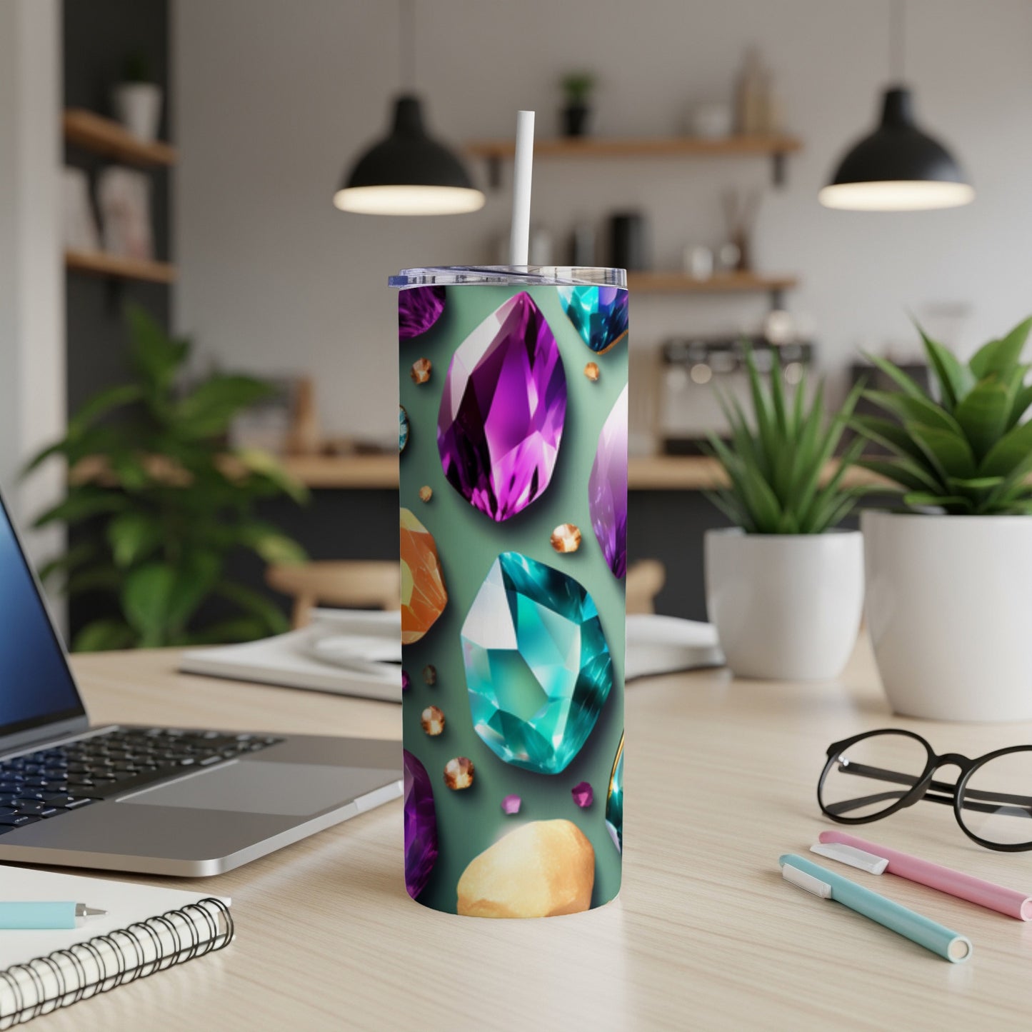 Tumbler with colorful gemstone pattern on a desk.