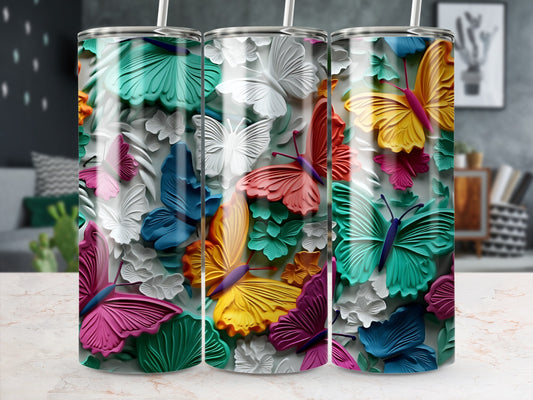 Three tumblers with colorful embossed butterflies and flowers.