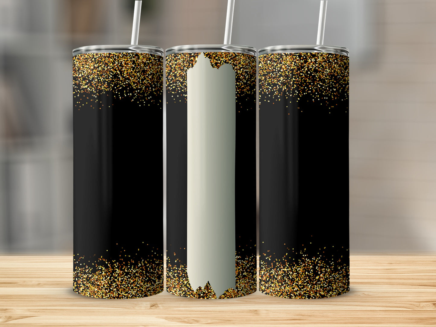 Three tumblers with gold glitter on black background, one center with blank white stripe.