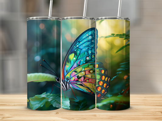 Butterfly tumbler with vibrant wings, against a blurred green background.