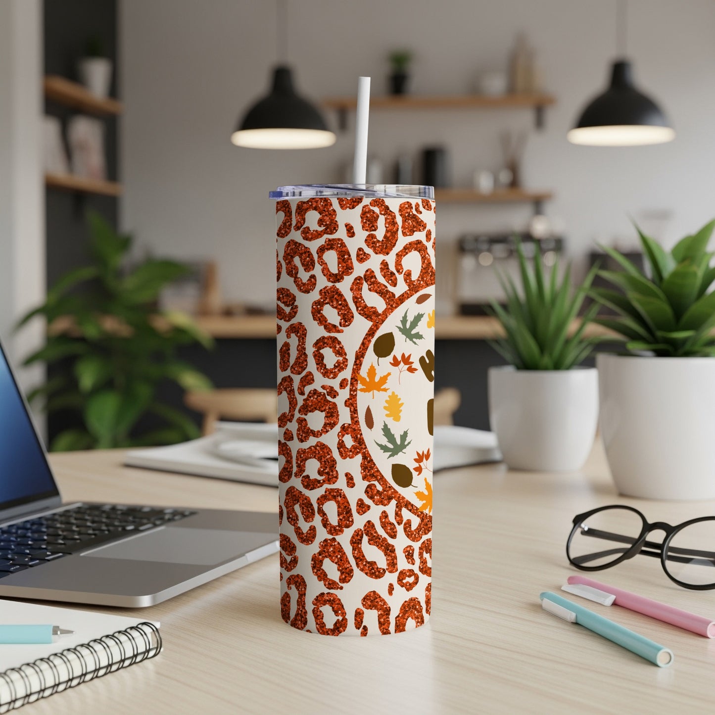 White tumbler with leopard print and autumn leaves design.