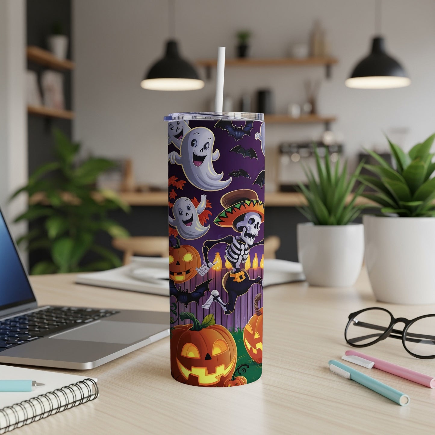 Tall tumbler with Halloween ghosts, skeletons, bats, and pumpkins on a purple background.
