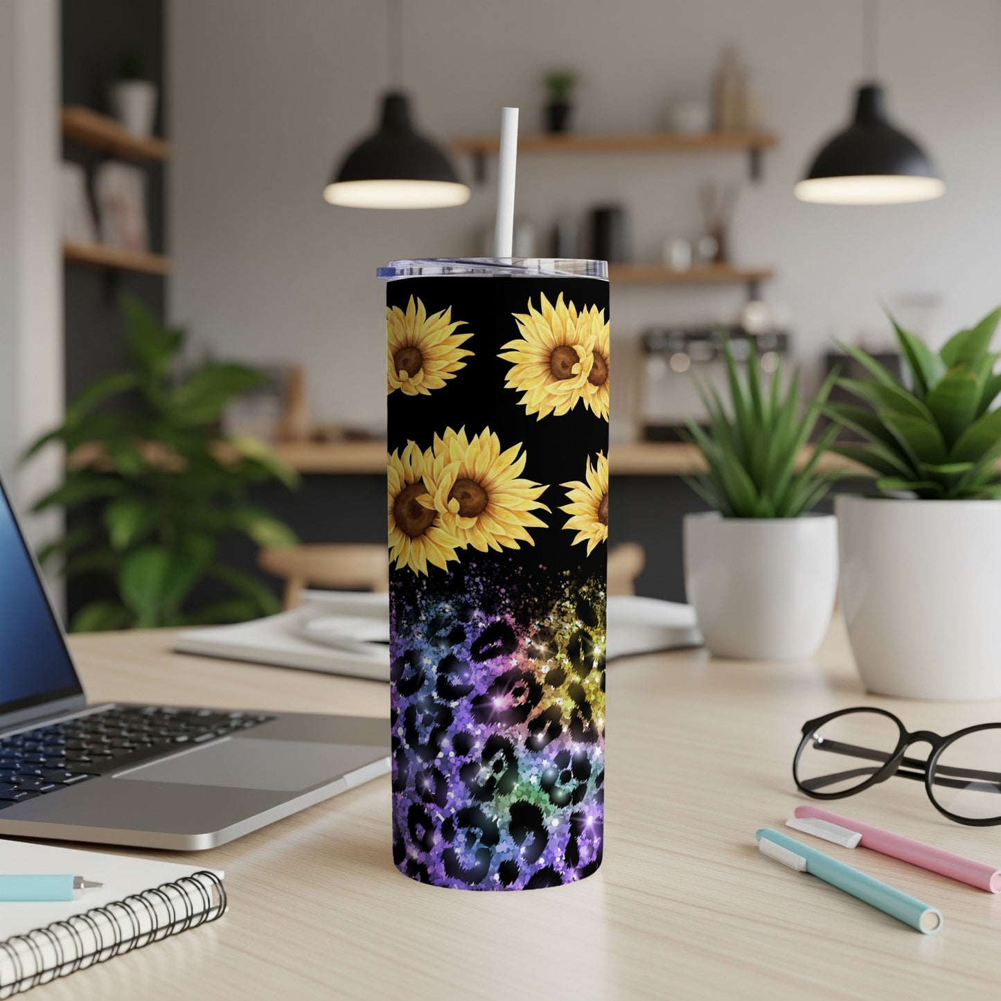 Tall tumbler with sunflowers and leopard print on desk.