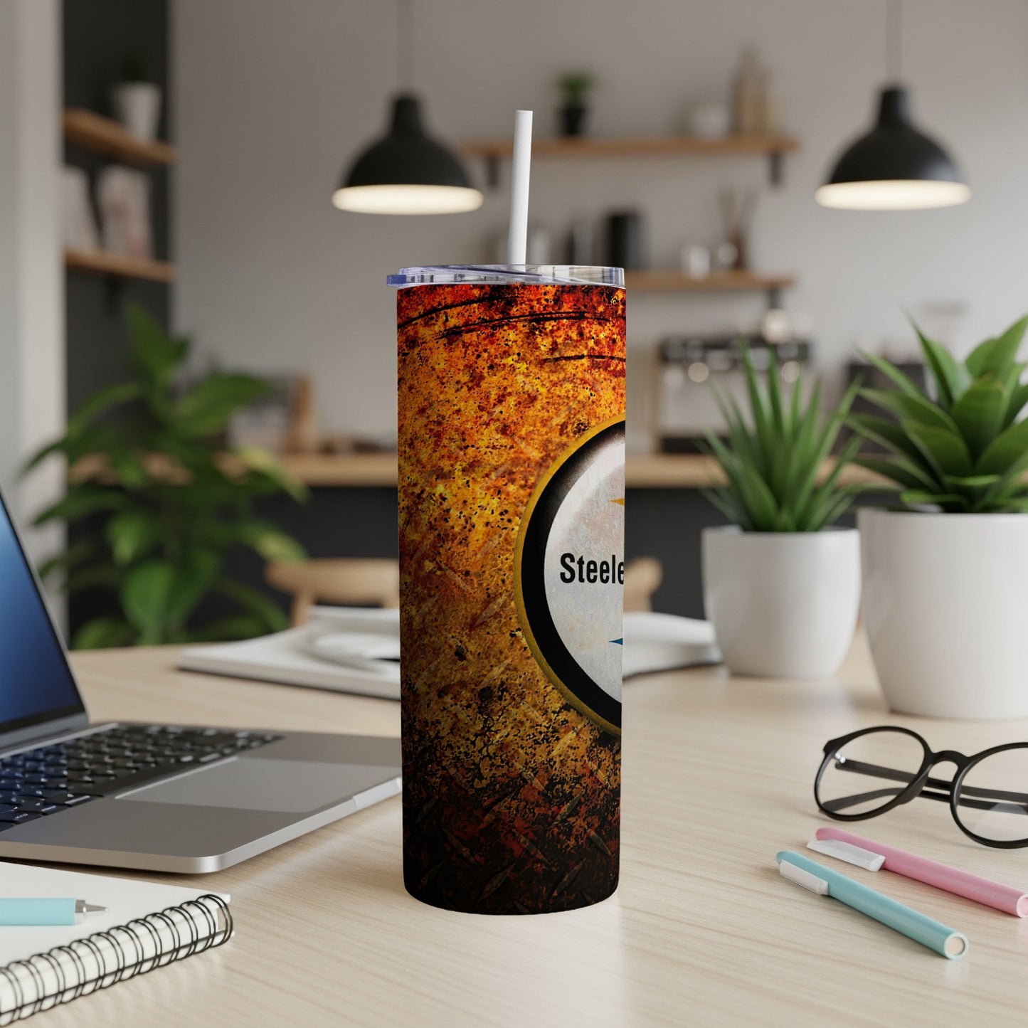 Pittsburgh Steelers tumbler with a distressed texture and logo, featuring a straw.