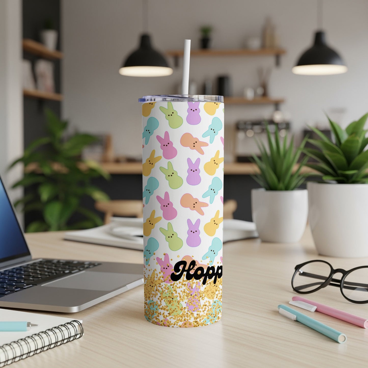 White tumbler with colorful Easter bunnies and "Hoppy" text.