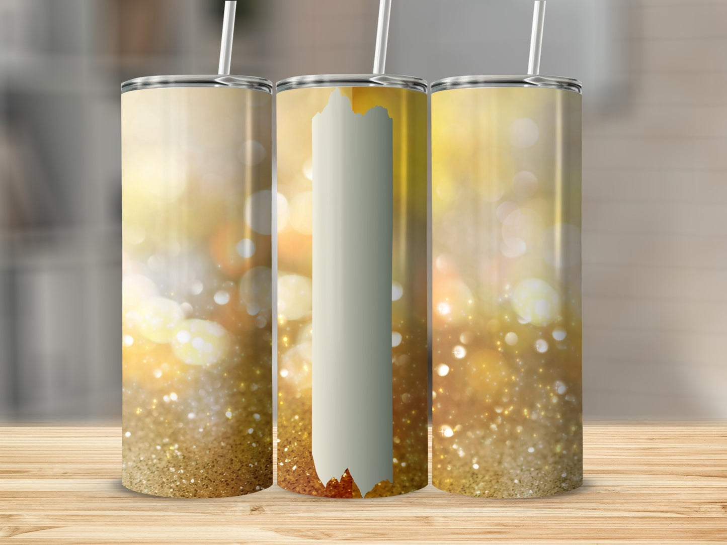 Three tumblers with gold glitter and bokeh background on a wooden surface.