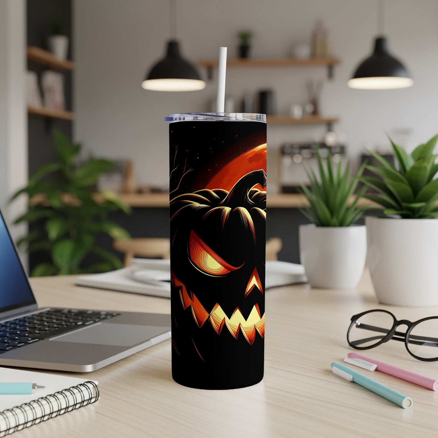 Black tumbler with a glowing jack-o'-lantern face and full moon against a dark sky.