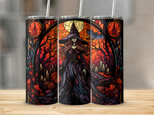 Three Halloween-themed tumblers with a witch and pumpkins, displayed on a wooden surface.