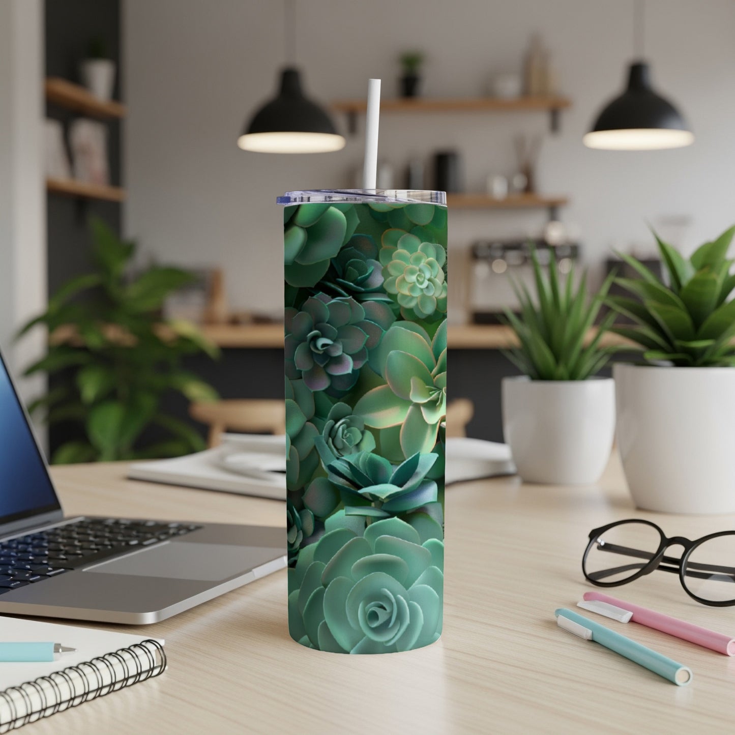 Green succulent pattern on a white tumbler with a straw.