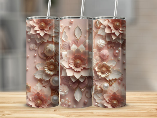 Three tumblers with floral and pearl embellishments on a wooden surface.