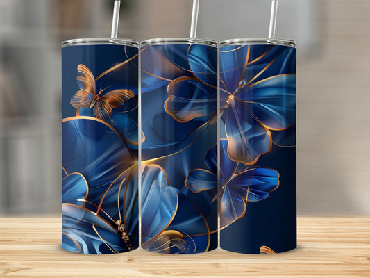 Three dark blue tumblers with golden floral and butterfly designs.