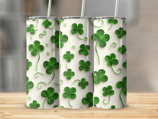 Three tumblers with green shamrock and swirl patterns on white.