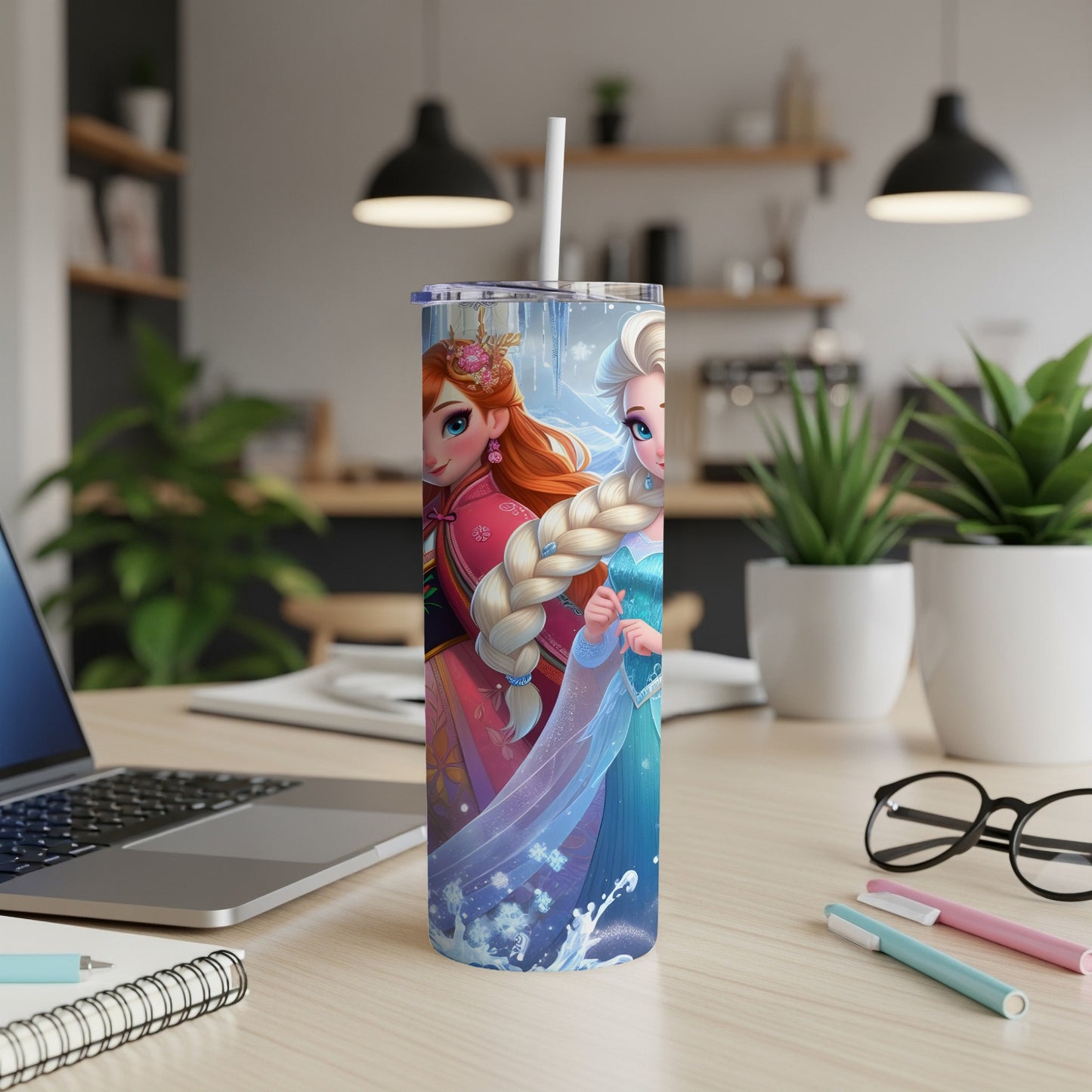 Anna and Elsa on a skinny tumbler with a straw in a home office setting.